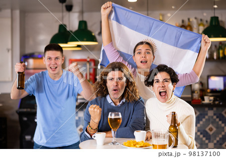 Happy fans celebrating the victory of Argentinean team in bar 98137100