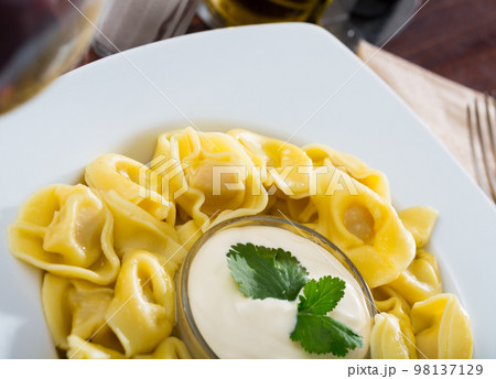 Closeup of ravioli with sauce 98137129