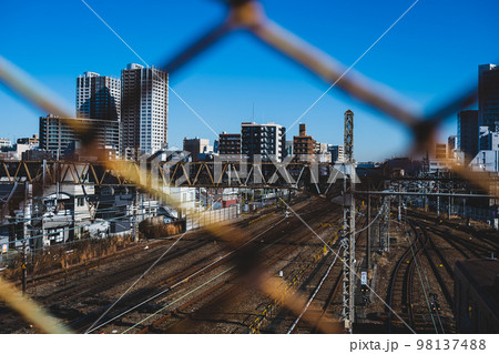 東京郊外 三鷹跨線橋の金網越しに見渡す電車庫と三鷹駅周辺 2022.12 マット感 東京郊外 三鷹跨線橋の金網越しに見渡す電車庫と三鷹駅周辺 2022.12 マット感 98137488
