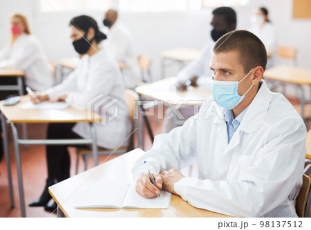 Group of medical academy students in protective masks at lesson 98137512