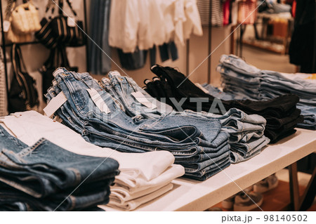 Stack Of Jeans On Shelves In Store Of Shopping Center. shelf display in shop mall store. Store Of Shopping Center. retail sale 98140502
