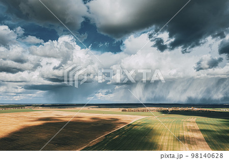 Scenic Sky With Fluffy Clouds On Horizon. Bird's-eye Aerial View. Amazing Natural Dramatic Sky With Rain Clouds Above Countryside Rural Field Landscape In Spring Summer Cloudy Day. Beauty In Nature Scenic Sky With Fluffy Clouds On Horizon. Bird's-eye Aerial View. Amazing Natural Dramatic Sky With Rain Clouds Above Countryside Rural Field Landscape In Spring Summer Cloudy Day. Beauty In Nature 98140628