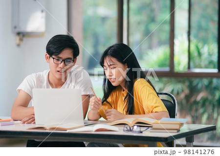 Young asian students campus helps friend catching up and learning. 98141276