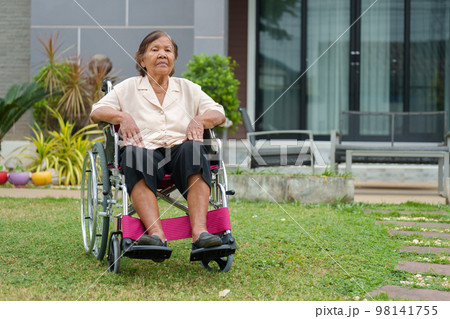 senior woman in wheelchair at outside the house senior woman in wheelchair at outside the house 98141755