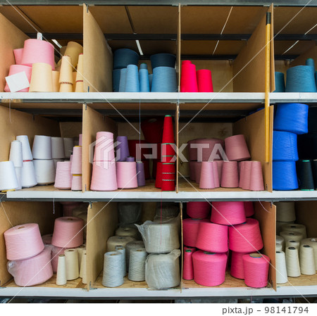 Spools with color thread at knitting factory view Spools with color thread at knitting factory view 98141794