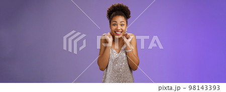 Excited good-looking happy lucky african-american woman winning money lottery casino standing amused thrilled wanna try more smiling broadly dancing clench fists rejoice triumphing 98143393