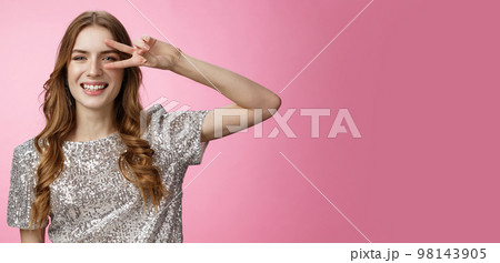Positive carefree lucky charming glamour woman curly hairstyle party outfit having fun showing victory peace gesture dancing disco smiling broadly enjoying awesome atmosphere, pink background Positive carefree lucky charming glamour woman curly hairstyle party outfit having fun showing victory peace gesture dancing disco smiling broadly enjoying awesome atmosphere, pink background 98143905