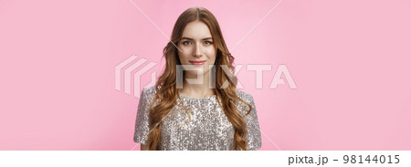 Close-up confident determined attractive stylish woman evening makeup curly hairstyle wearing party outfit smiling self-assured, dress-up evening dance club, standing happily pink background 98144015