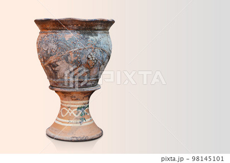 old and dirty brown and black clay pot is placed on a brown and black clay pedestal on pink background, object, decor, vintage, old, copy space old and dirty brown and black clay pot is placed on a brown and black clay pedestal on pink background, object, decor, vintage, old, copy space 98145101