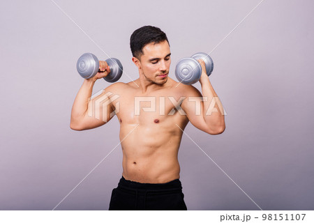 Shirtless bodybuilder showing his great body and holding dumbell. Shirtless bodybuilder showing his great body and holding dumbell. 98151107