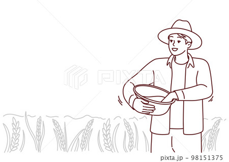 Male farmer working in field 98151375