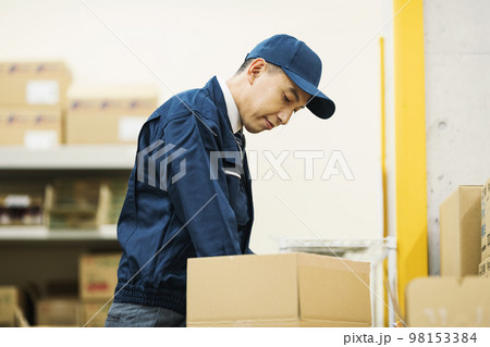 物流倉庫で仕分けをする作業服の男性 98153384