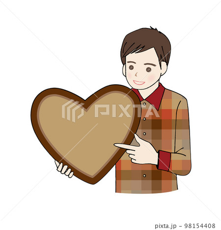ハートのチョコレートを持って指さす男性  テキストスペース 98154408