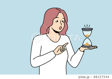Shocked woman look at hourglass  98157544