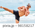 Young healthy man workout exercise on the beach at daytime 98158217