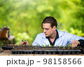 Portrait of handsome agricultural researcher working on research at plantation in industrial greenhouse 98158566