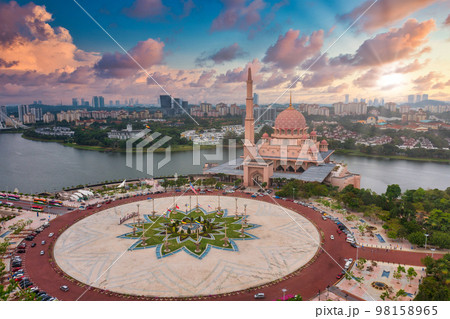 Aerial View Of Putra Mosque with Putrajaya City Centre with Lake at sunset in Putrajaya, Malaysia. Aerial View Of Putra Mosque with Putrajaya City Centre with Lake at sunset in Putrajaya, Malaysia. 98158965