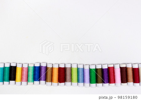 Set of multi-colored skeins of thread on a white background with place for text. Sewing or tailor shop, for advertising Set of multi-colored skeins of thread on a white background with place for text. Sewing or tailor shop, for advertising 98159180