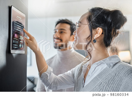 Smart home technology, wall system and couple with digital dashboard for air conditioning, safety security network or house automation. App software, ui panel and Asian people programming IOT monitor Smart home technology, wall system and couple with digital dashboard for air conditioning, safety security network or house automation. App software, ui panel and Asian people programming IOT monitor 98160334