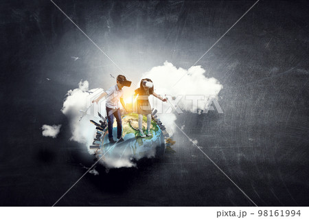 Kids wearing virtual reality goggles 98161994