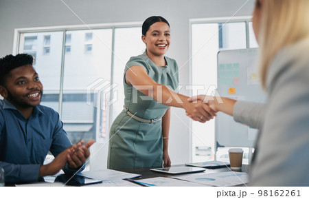 Business people, woman and handshake at meeting, planning and chart on board for target, success or goal. Corporate finance group, applause and celebration for profit, promotion or vision in New York 98162261
