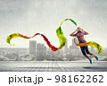 Woman wearing headphones jumping . Mixed media 98162262