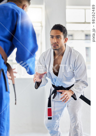 Men, martial arts and karate training in dojo to practice fighting skill. Taekwondo, fitness or self defense class for workout, battle exercise or sports challenge of people in match or competition. Men, martial arts and karate training in dojo to practice fighting skill. Taekwondo, fitness or self defense class for workout, battle exercise or sports challenge of people in match or competition. 98162489