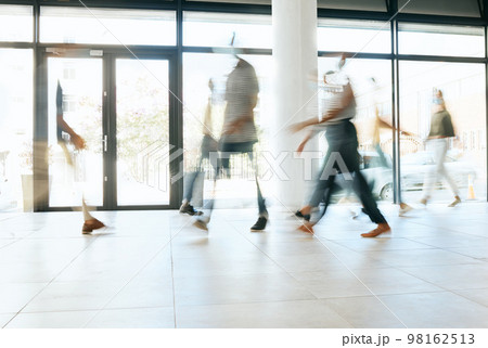 Motion blur, busy office and business people walking, moving or fast speed in workplace, startup company or agency. Group of workers, crowd and employees rush movement in lobby, building and hallway Motion blur, busy office and business people walking, moving or fast speed in workplace, startup company or agency. Group of workers, crowd and employees rush movement in lobby, building and hallway 98162513