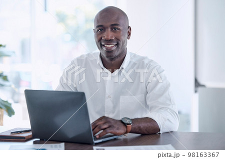 Ceo, black man and portrait at office laptop with smile working on report for marketing company. Professional corporate worker at workplace desk with document for project development. 98163367