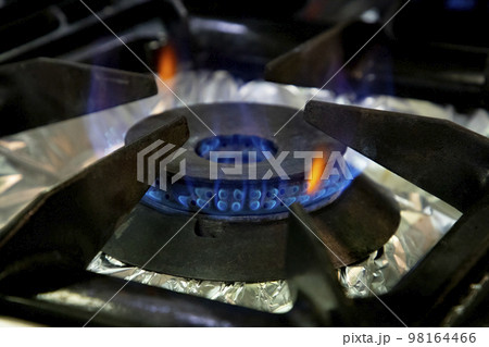 Stoves. Kitchen room. Gas stove with burning propane gas flames. Concept of industrial resources and economy. Stoves. Kitchen room. Gas stove with burning propane gas flames. Concept of industrial resources and economy. 98164466