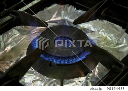 Stoves. Kitchen room. Gas stove with burning propane gas flames. Concept of industrial resources and economy. Stoves. Kitchen room. Gas stove with burning propane gas flames. Concept of industrial resources and economy. 98164483