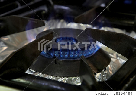 Stoves. Kitchen room. Gas stove with burning propane gas flames. Concept of industrial resources and economy. Stoves. Kitchen room. Gas stove with burning propane gas flames. Concept of industrial resources and economy. 98164484