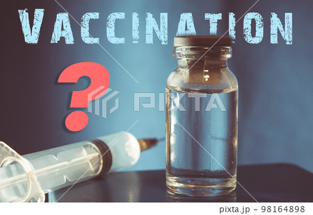 Vaccine in vitro. Medicine in a flask on a blue background. Vaccine in vitro. Medicine in a flask on a blue background. 98164898