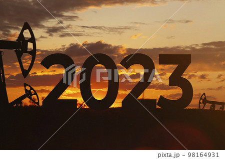 Oil production against backdrop of beautiful sunset. 2023 and oil fields.  98164931