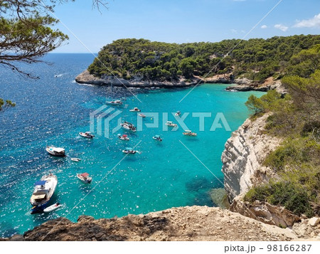 View of turquoise sea in beautiful bay Cala Mitjaneta in Menorca 98166287