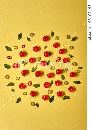 Ripe red cherry tomatos on yellow wall background. Flat lay copy space Ripe red cherry tomatos on yellow wall background. Flat lay copy space 98167443