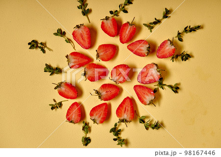 top view on strawberry fruits with leafs lying on yellow background, flat lay. top view on strawberry fruits with leafs lying on yellow background, flat lay. 98167446