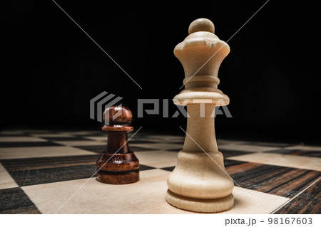 Chess game with chess pieces against black background Chess game with chess pieces against black background 98167603