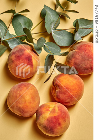 Peach collection. Fresh honey fruit with leaf isolated on yellow background. 98167743