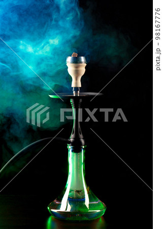 Smoking hookah on black background with color fog 98167776