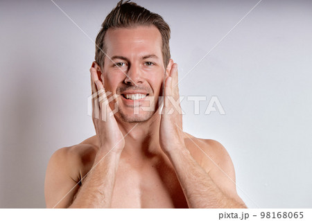 Close-up portrait of happy caucasian guy with wet sexy body posing, touching face Close-up portrait of happy caucasian guy with wet sexy body posing, touching face 98168065