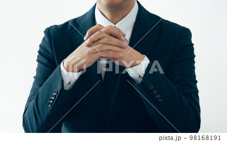 手を組んで話を聞くビジネスマン 98168191