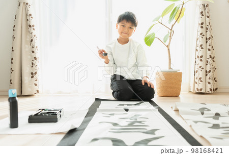 書き初めを書く日本人の小学生の男の子 98168421