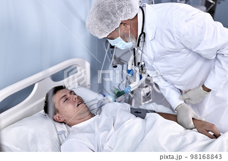 Senior Male Doctor Check the Pulse and the Patient's Health Condition Lying On Bed Senior Male Doctor Check the Pulse and the Patient's Health Condition Lying On Bed 98168843