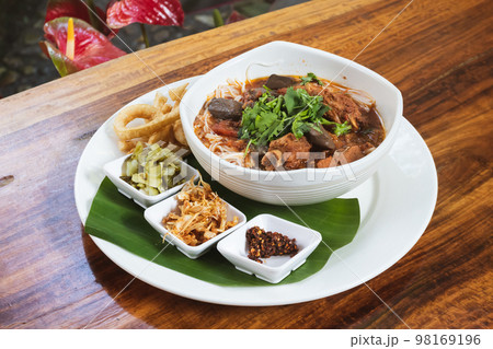 Thai Food, Rice vermicelli in northern thai red curry sauce with pork ribs and pork blood curd. Thai Food, Rice vermicelli in northern thai red curry sauce with pork ribs and pork blood curd. 98169196