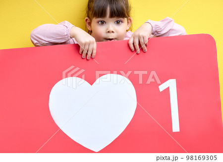 shocked little girl get a lot of likes and attention in blog, , portrait of young blogger with like sign shocked little girl get a lot of likes and attention in blog, , portrait of young blogger with like sign 98169305