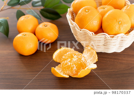 皮を剥いたみかんとたくさんのみかん 98170337