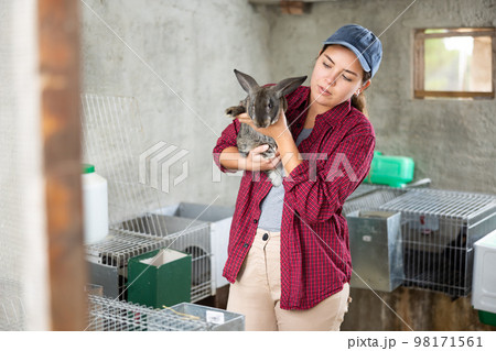 Young woman with a rabbit in her hands Young woman with a rabbit in her hands 98171561