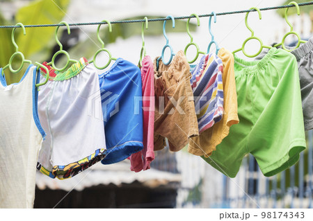 clothes trousers hangers dry outside of baby arrangement on cord  98174343