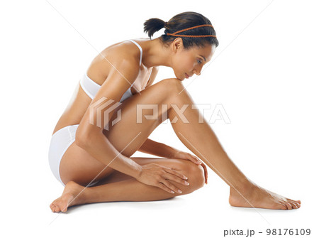 Body care, beauty and woman in underwear in a studio with a wellness, skin care and natural routine. Cosmetic, spa and female model from Mexico with a smooth body treatment posing by white background Body care, beauty and woman in underwear in a studio with a wellness, skin care and natural routine. Cosmetic, spa and female model from Mexico with a smooth body treatment posing by white background 98176109